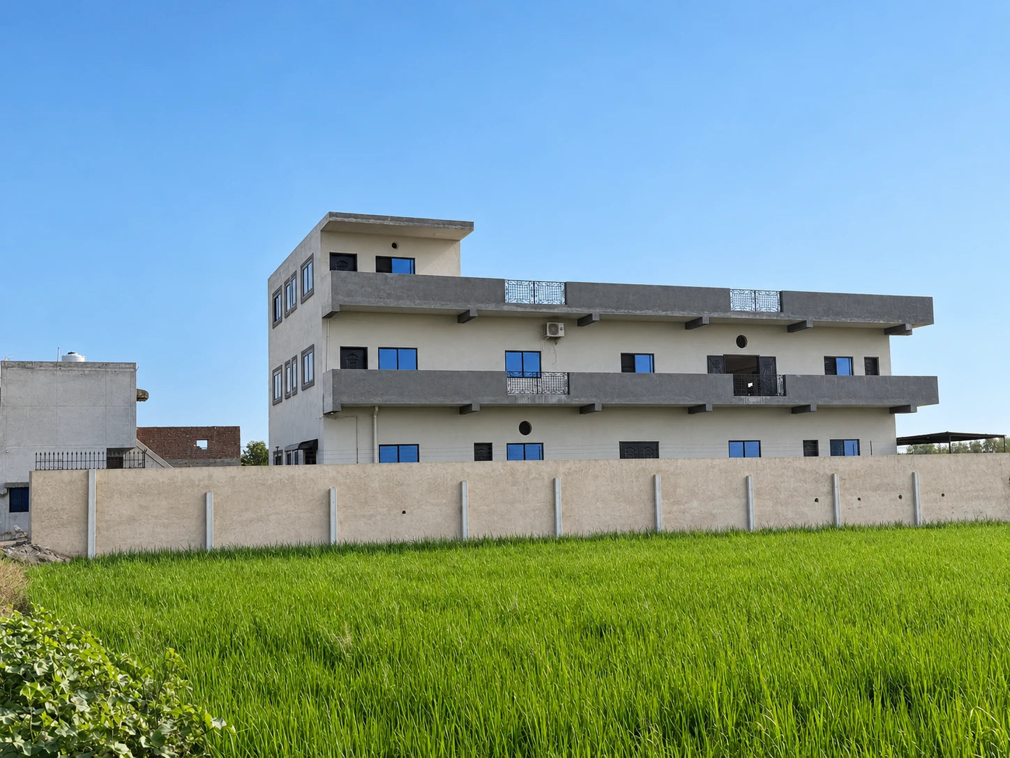 Exterior of the family-owned garment manufacturing facility, with fields in the foreground
